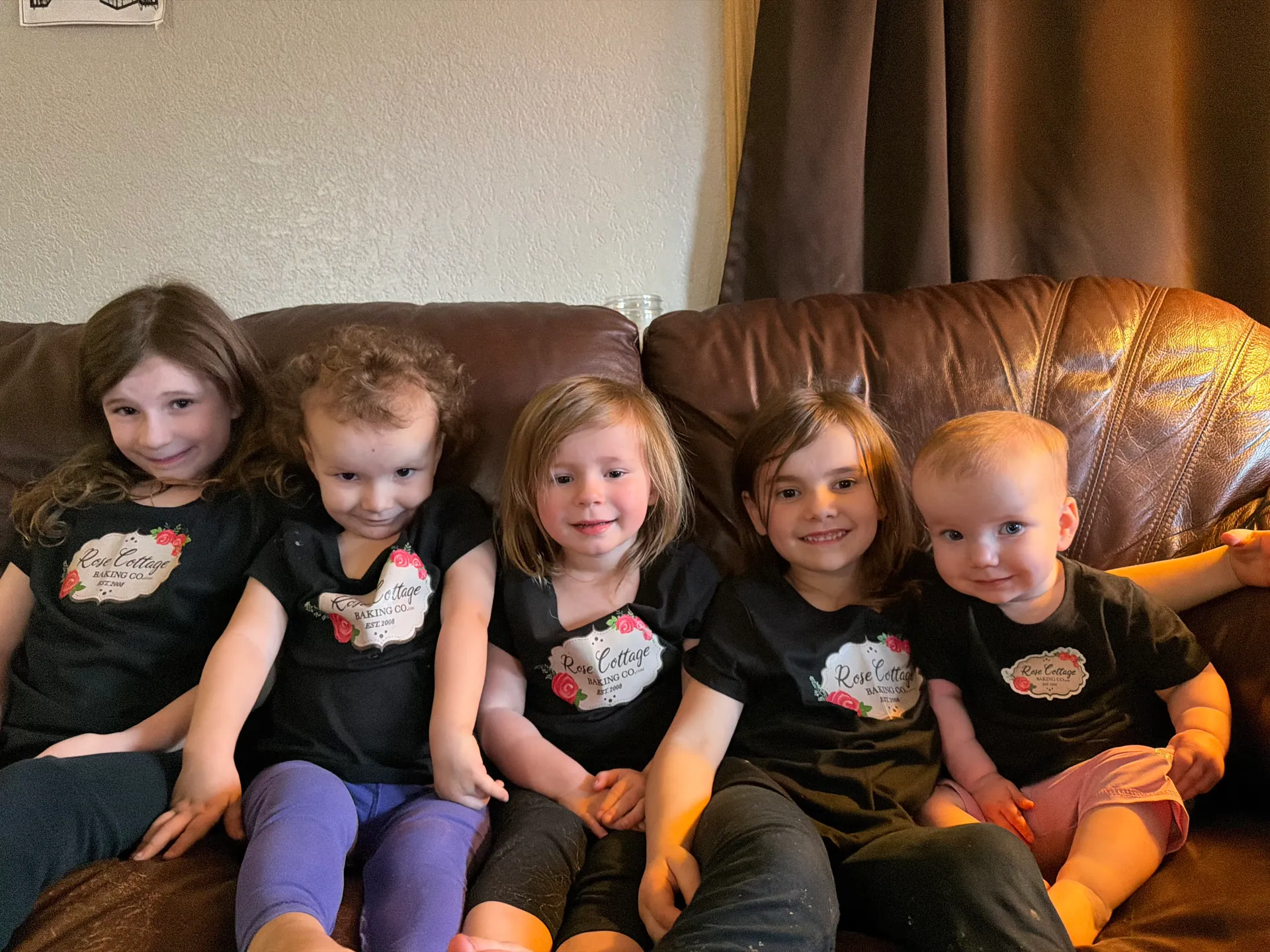 Young children in Rose Cottage Baking Co. shirts — the family heart of the Cook, MN bakery
